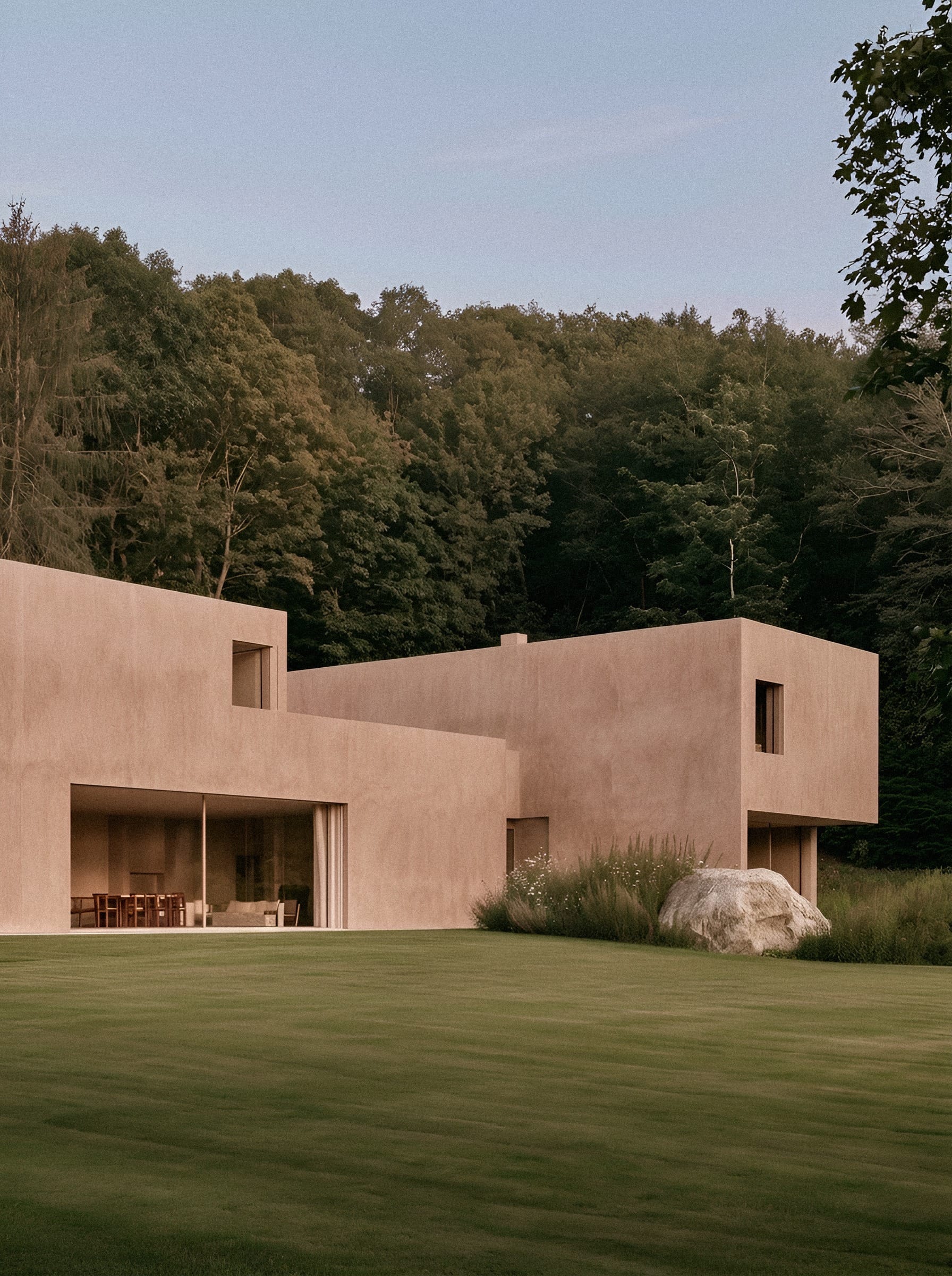 Terracotta house with forest backdrop.