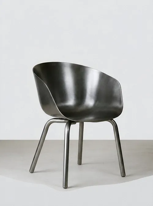 Curved metal chair on gray floor.