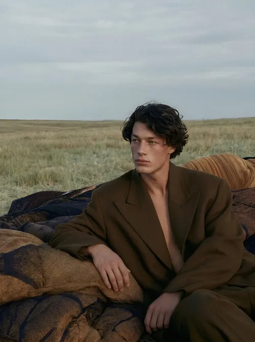 Man on fabric in open field.